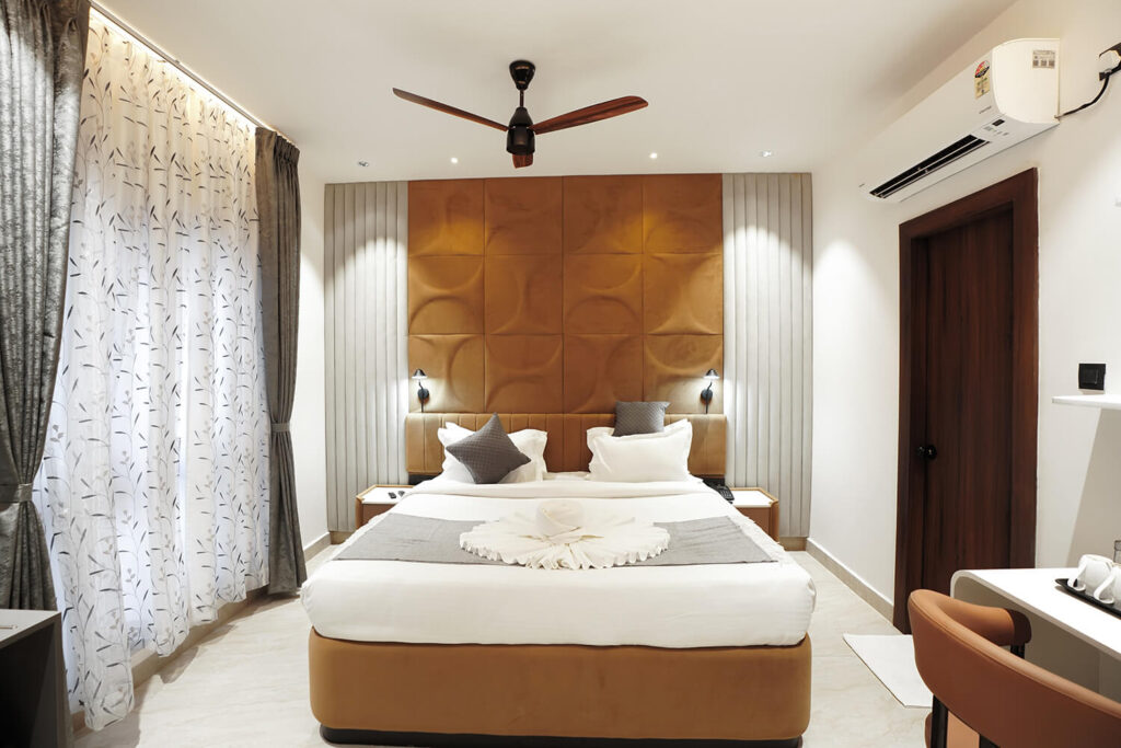 King size bed in a modern room at Sreeshrestam Apart Hotel, Hyderabad