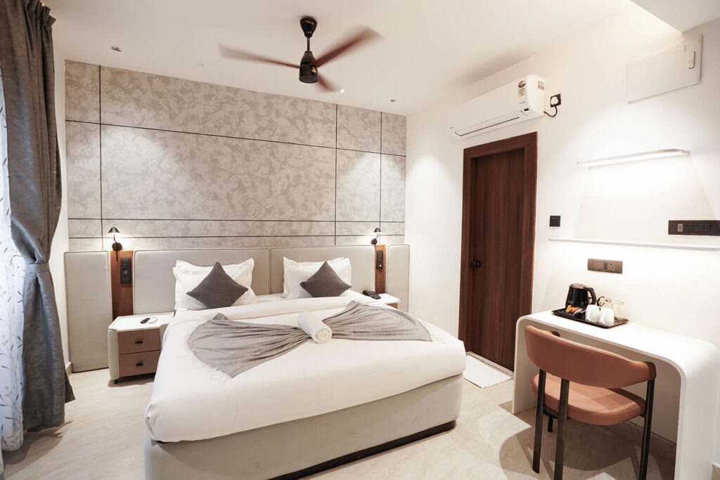 King room interior with king-size bed, work desk, and modern amenities at Sreeshrestam Apart Hotel, Hyderabad