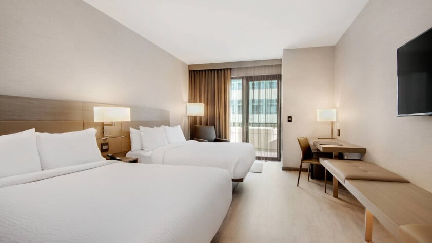 Spacious twin bedroom with modern interiors at Sreeshrestam Apart Hotel, Hyderabad